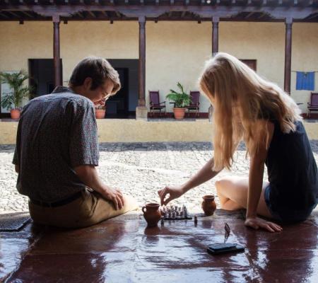 Two UT students play chess in the commons area of Casa Herrera, the research center based out of Guatemala 