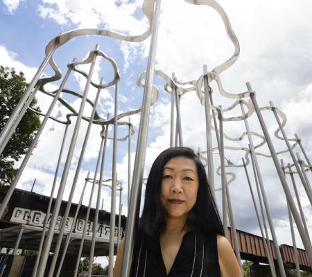 Artist and Studio Art faculty member Beili Liu in front of downtown Austin sculpture Cloud Pavilion