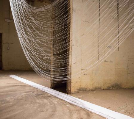 image of string suspended in silo in one large swoop