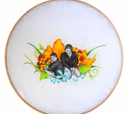 Embroidered flowers with pen and ink Latinx people on framed white fabric