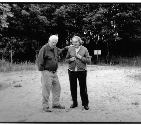 black and white image of calder and pedrosa talking together for lecture at the University of Texas at Austin