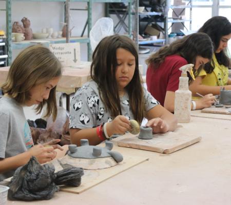 Class of middle schoolers working on art projects at UT Austin