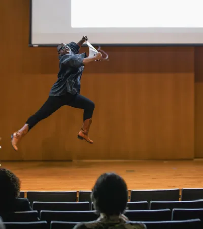 autumn knight jumping off a chair during artist talk