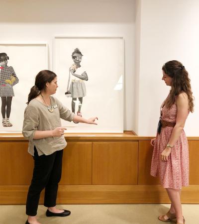 person discussing a work of art with another person