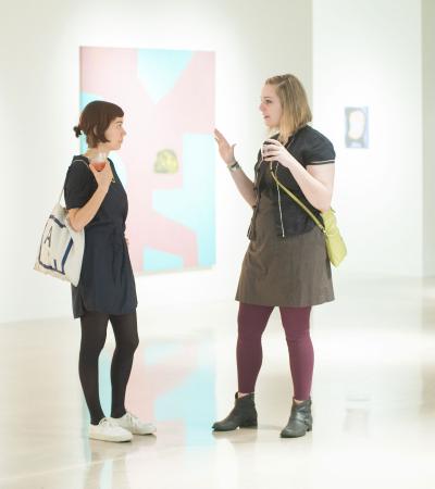two people talking in a gallery