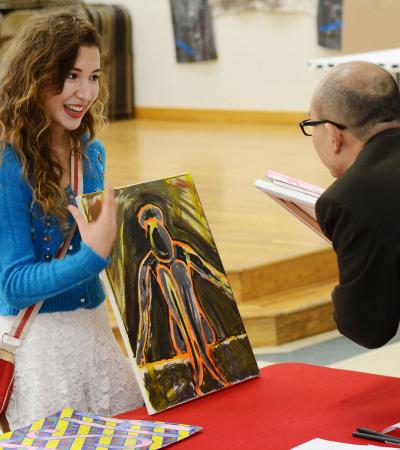 student showing painting during a portfolio review