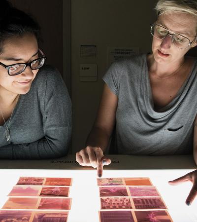 students looking at film negatives on light table