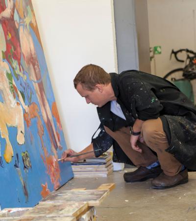 student painting on a canvas