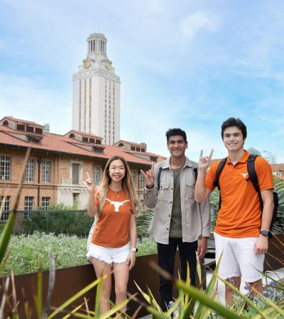 students posing for photo with UT Tower in background