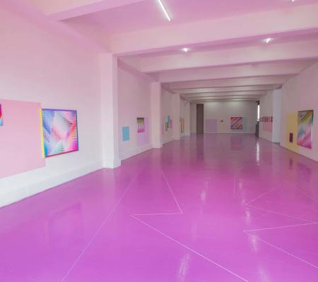 image of gallery floor painted pink and electric paintings on its walls