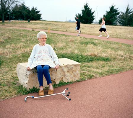 old woman sitting on park bench