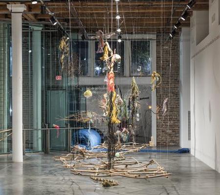 installation view of multiple items strung in space