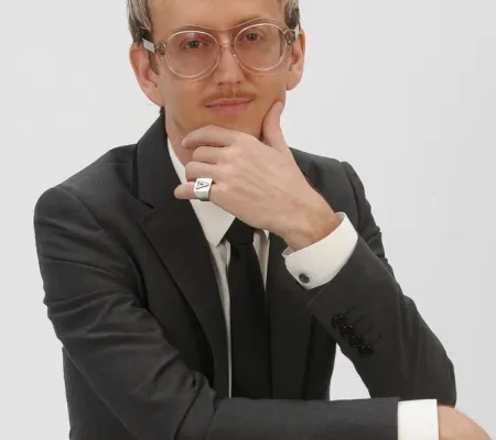 image of a portrait of blond man Alton DuLaney holding hand up to his chin