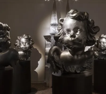 Angel statues with tape over their mouths.