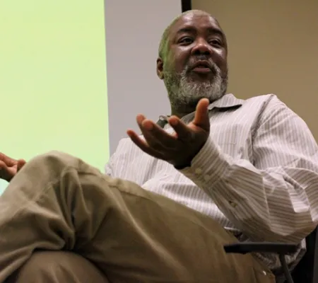 dr Eddie Chambers addressing an unseen audience on a panel