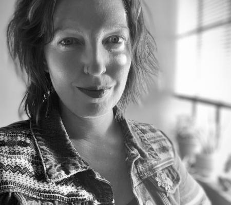 black and white headshot image of curator Laura August