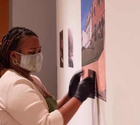 Senior Studio Art major Madison Cooper installing work for her solo exhibition curated by Center Space Project and exhibited at the Visual Arts Center