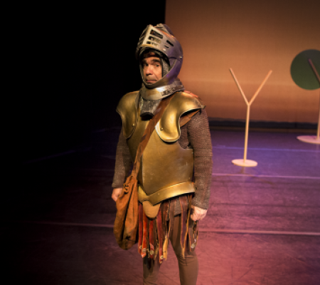 man standing in suit of armor on stage