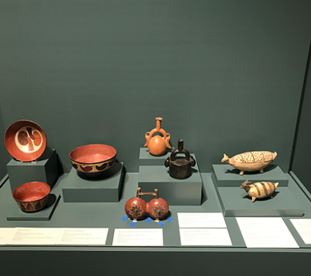 three images of andean ceramics being installed into a museum with the help of preparatory and curators