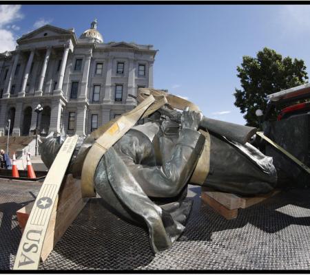 A Civil War monument statue is strapped to the back of a flatbed after it was toppled from its pedestal in front of the State Capitol to illustrate an opinion piece by University of Texas at Austin Art History Professor Eddie Chambers piece