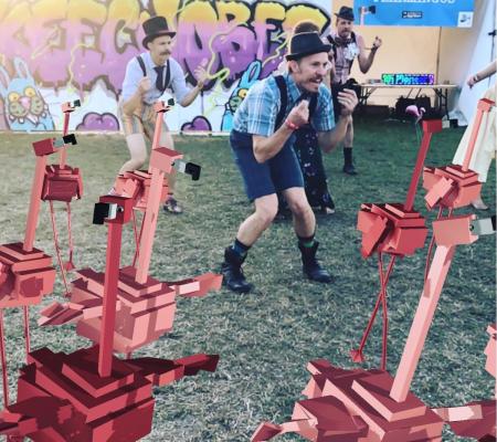 augmented reality flamingos dancing with crowd at festival
