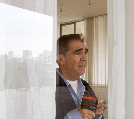 man staring out of hotel window