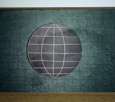 green gridded canvas propped up against wall with a painted large black circle
