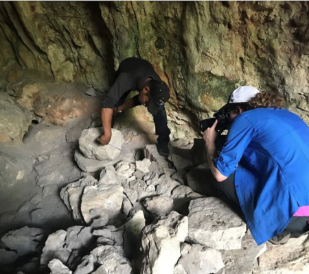 documenting ancient Maya sculptures in a cave in Guatemala with Julian Camposeco, a member of Proyecto Arqueológico de la Región de Chaculá. Photo taken pre-pandemic; by Byron Hernández