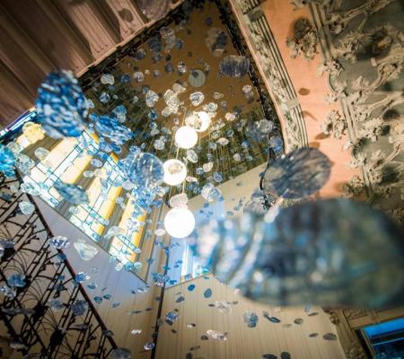 image of installation with silk organza cyanotype pieces in resin hung from a high ceiling