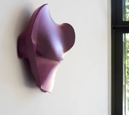 acrylic geometric form attached to white wall