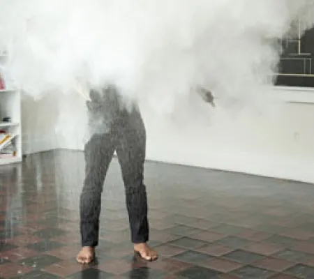 clifford owens during a performance with chalk obscuring face and torso