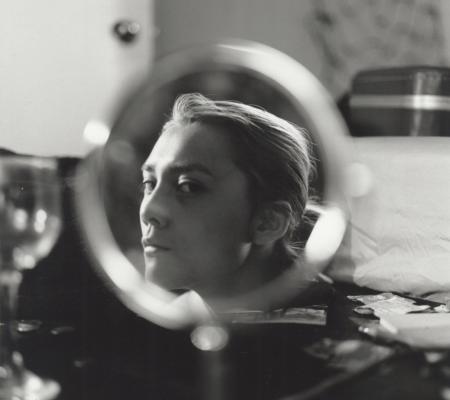 a women in profile reflect through a vanity mirror in black and white