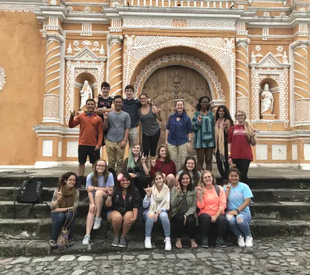 image of group of students and professor in front of belize site