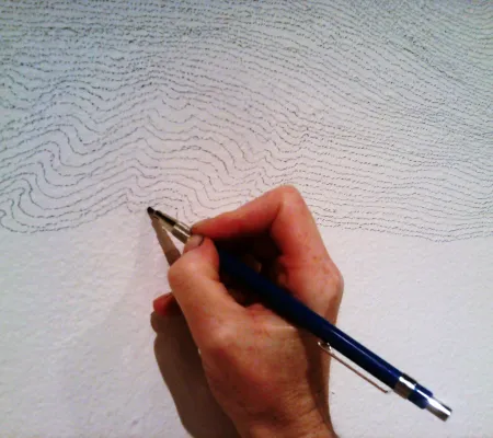hand holding pencil drawing consecutive lines