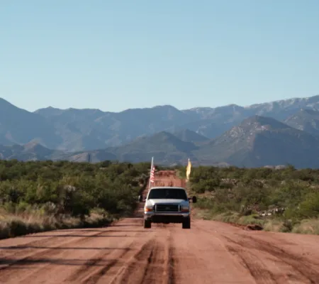 image still from a video from Mexico City based artist Joshua Ikon of a car driving down a deserted highway