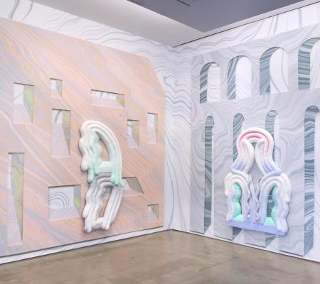 gallery installation image of lots of pastel marbleized surfaces and sculptures layered on one another 