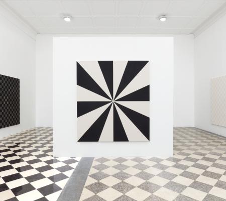 black and white artwork in the middle of a wall in a gallery