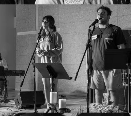 black and white image of two students at a worship group