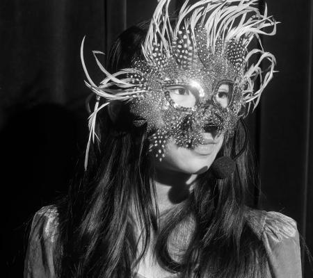 image of young girl wearing animal mask in black and white