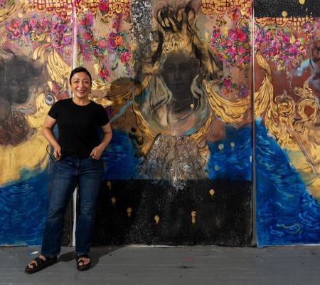 image of woman in front of large painting