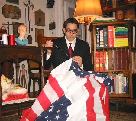 image of Nicolas Estevez sewing a flag for performative piece