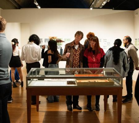 image of people in a gallery looking at a new exhibition