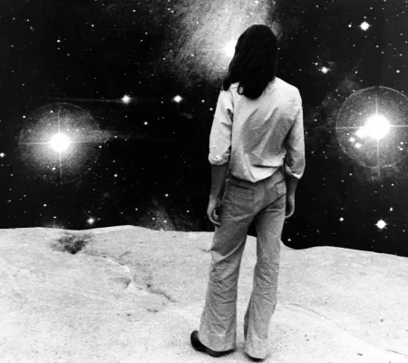 black and white image of man looking at stars