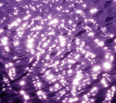 surface of water with ripples and cast in purple hue