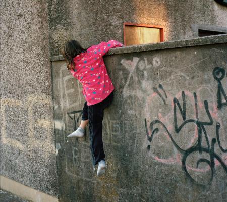 image by Doug Dubois of a girl climbing a wall