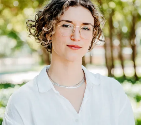 headshot image in front of greenery