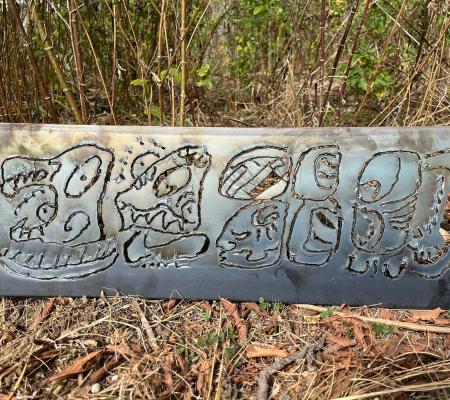 sheet of steel engraved with Maya glyphs