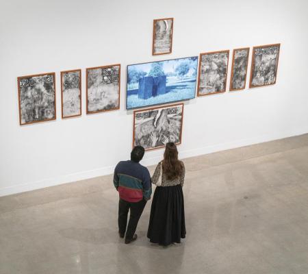 image of two people looking at an installation