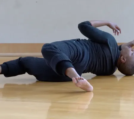 person laying on floor in twisted position