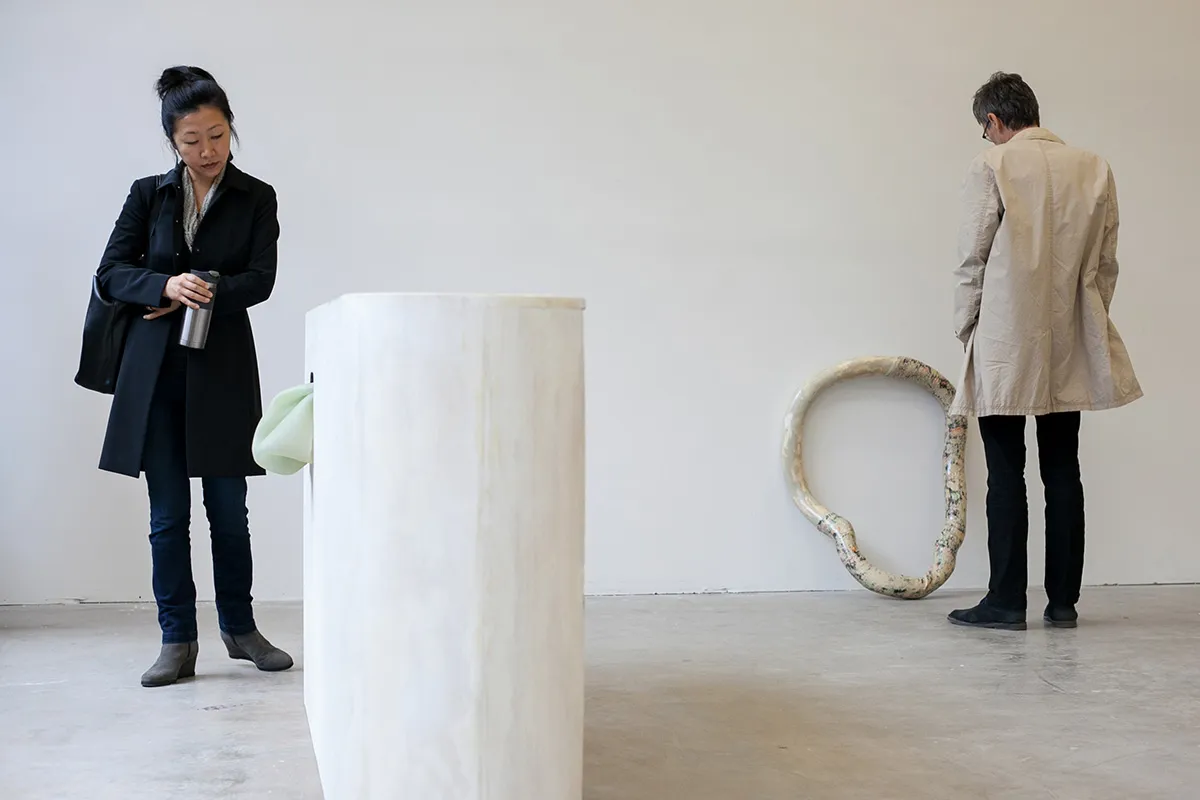 faculty looking at artwork in studio